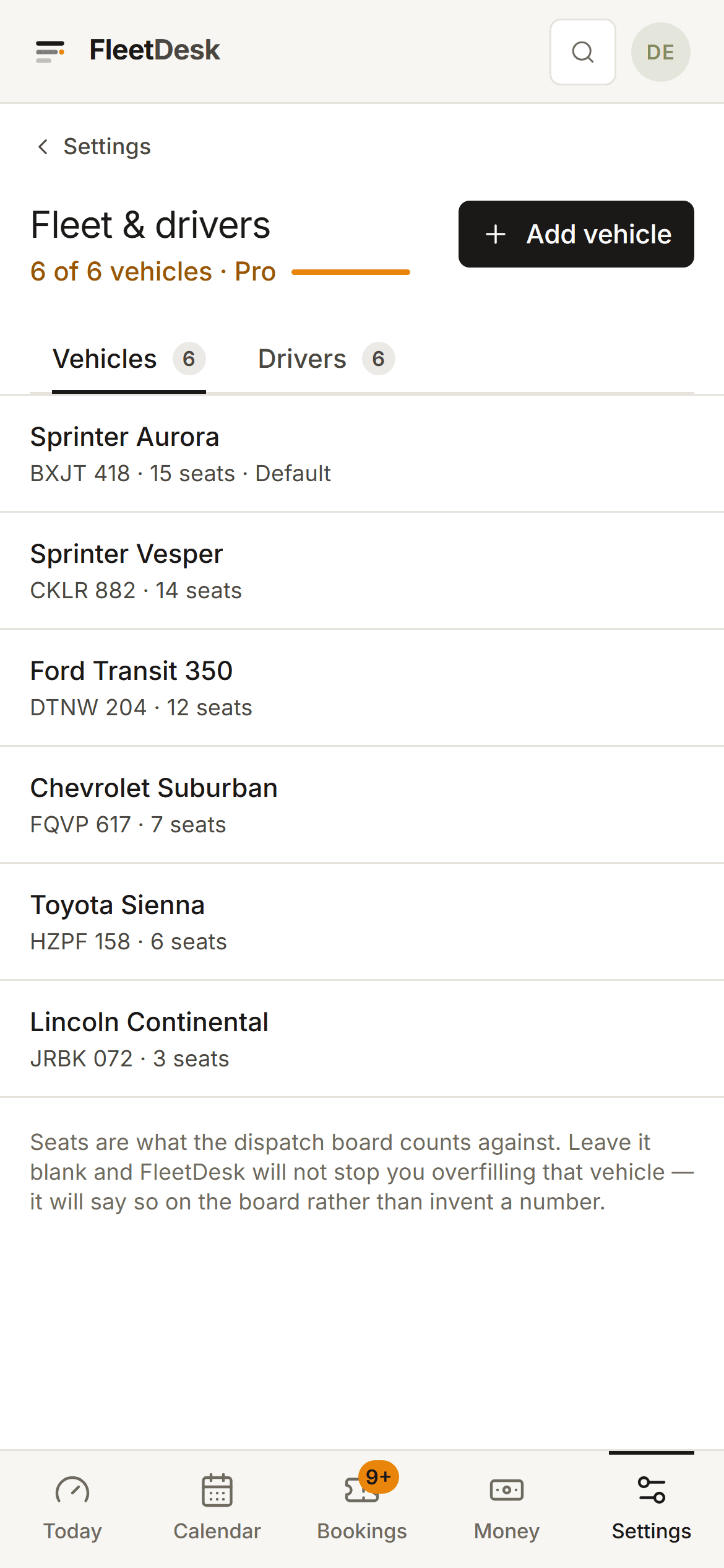 The FleetDesk fleet screen on a phone, in Settings: each vehicle's name, plate and seat count stacked as one card per vehicle, with a note on how many the current plan covers.